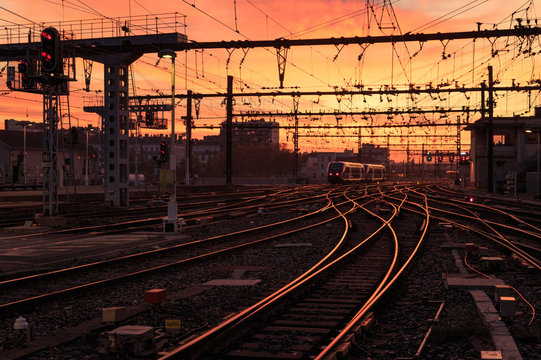 Fototapeta A train on the railroad tracks  during sunrise. Gare de Lyon-Perrache, Lyon, France.
