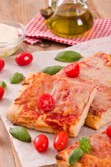 Italian pizza with cheese, tomatoes and fresh basil. 
