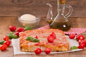 Italian pizza with cheese, tomatoes and fresh basil. 