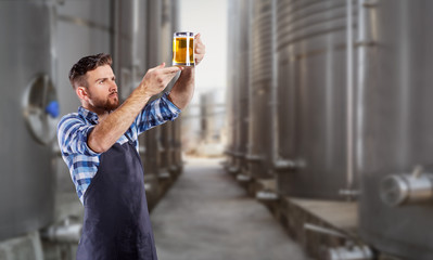 Brewer man with a glass of beer in his hand.