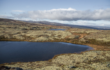 A beautiful mountain lake high above the sea level in Norway. Colorful autumn landscape with lake.