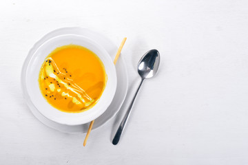 Pumpkin Soup. On a wooden surface. Top view. Free space for your text.