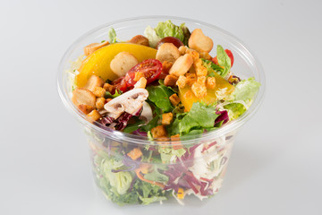 Fresh salad cup container on white background © OceanProd