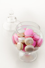 Macarons in a glass vase on a white background. Sweet macarons. Top view with copy space. Party sweets. Happy luxury birthday and wedding concept.