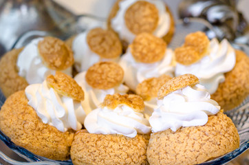 Delicious wedding reception sweets dessert from the sand dough with white cream on glass plate. Candy bar desser.