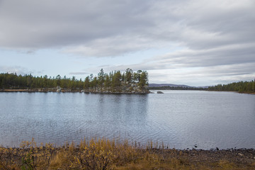 A beautiful lake landscape in Femundsmarka National Park in Norway. Lake with a distant mountains in background. Beautiful autumn scenery with vivid colors.