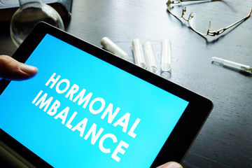 Hormonal imbalance sign on a tablet.
