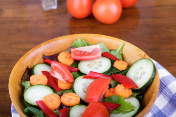 Large Mixed Salad in Wood Bowl with Fresh Tomatoes