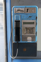 blue public payphone in a street of Spain