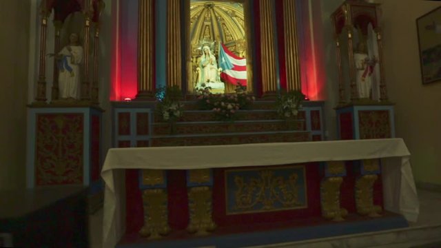 Beautiful altar at a church with candles and a Puerto Rican flag