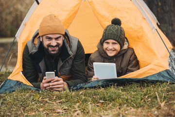 Father and son lying in tent