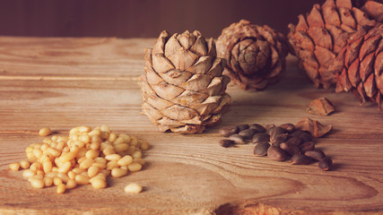 Pine nuts and cones on a wooden table