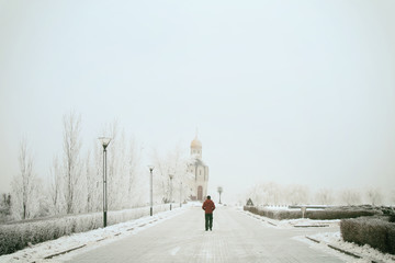 A passer-by on a winter snow-covered street