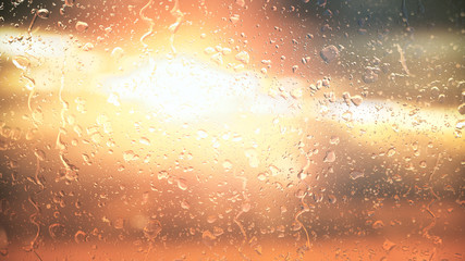 The sun in the clouds shines through the glass in the rain drops illustration