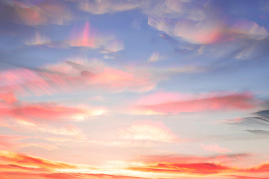 Overlay several photos on each other in a time lapse. Colorful watercolor clouds in the sky