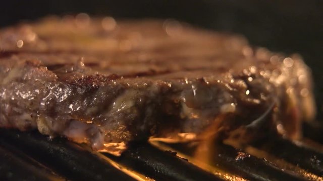 Sirloin aged prime rare roast isolated grilling pork filet with stripes slow motion. Close up blurred concept of cooked oil unhealthy, but very satisfying protein tasty burger in casual bar or cafe