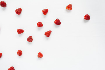 Raspberries on white background. Food blog or magazine concept texture.