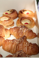 Croissant and egg tart in white box.