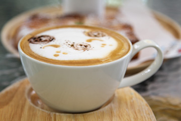 Hot cappuccino on wooden tray in morning time.
