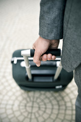 businessman pulling a trolley case