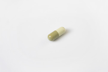 alone green medicine pill on white background