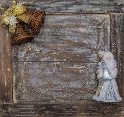 Christmas bells and decorations on an old oak board