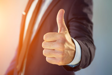 Businessman giving a thumb up on a color background