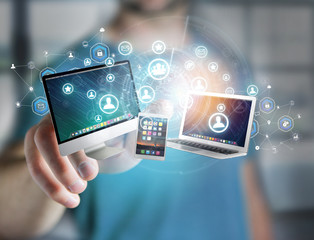 Computer and devices displayed on a futuristic interface with business network - Multimedia and technology concept
