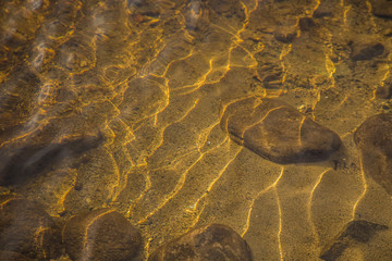 A beautiful river flowing through the Norwegian forest in autumn. Colorful landscape of fall.