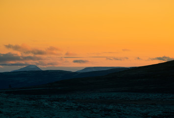 Fototapeta premium A beautiful, colorful sunset in mountains. Beautiful autumn in Norway. Abstract colorful look.
