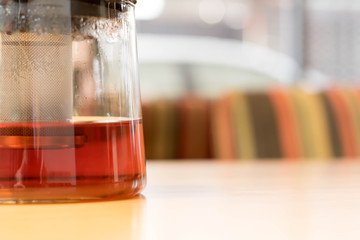 tea pot on a wooden table in a Cafe close-up with copy space
