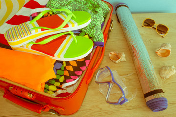 Open suitcase with clothes and personal things packed for travelling. Travel concept. Open traveler's bag with clothing, accessories