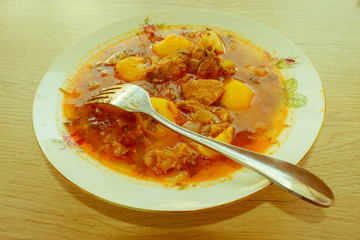 A bowl of delicious beef and tomato, potato