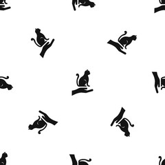 Hand holding a cat pattern seamless black