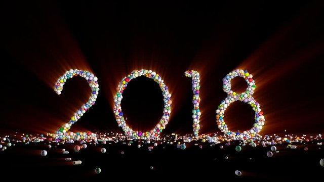 New Year 2018 sign made from colorful globes, light rays