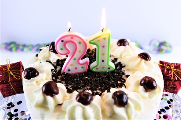 An Image of a birthday cake with candle - 21
