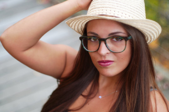 young woman wearing hat and glasses portrait beautiful girl close-up