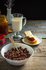 chocolate balls and a variety on the morning table (flakes, coffee, bread and butter)