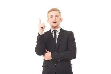 Portrait of young creative businessman in black suit on white background