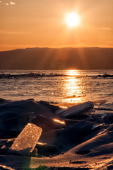 Field of ice hummocks on the frozen Lake Baikal. Sunset