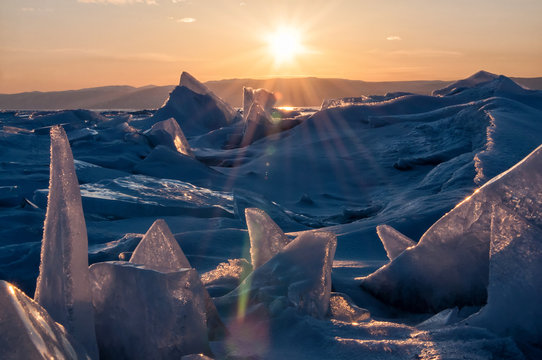Field of ice hummocks on the frozen Lake Baikal. Sunset © kuzenkova