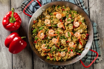 Traditional seafood paella with shrimp, fish and chicken seved i