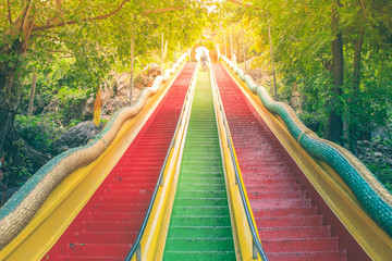Colorful stairs going up to top floor of Thum Sua Temple or Tiger Cave Temple, Kanjanaburi Provine, Thailand.
