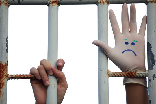 emojicon "sad" face on hand of prisoner
