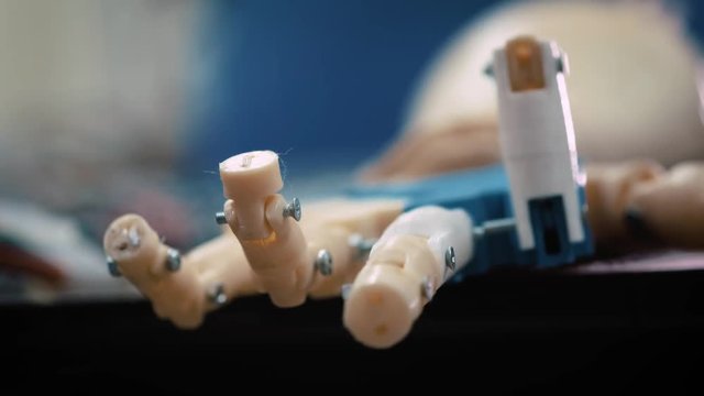 Futuristic robotic cyborg arm in action. Real robotic prosthesis. modern medical technologies in limb prosthetics. The android's hand moves with mechanical fingers in test mode.