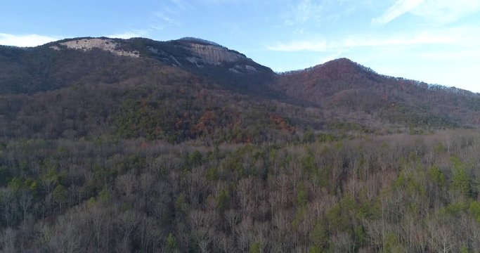Aerial drone footage of a mountain in the forest