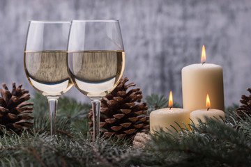 Closeup two glasses wine and candles. New Year celebration