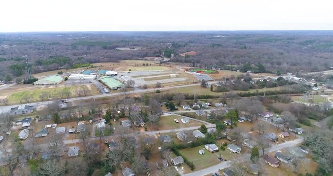 Aerial drone footage over houses and a campus