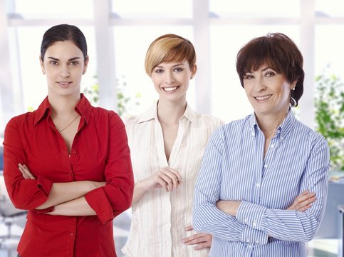 Group portrait of confident female office workers