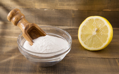 Lemon and baking soda on wooden table